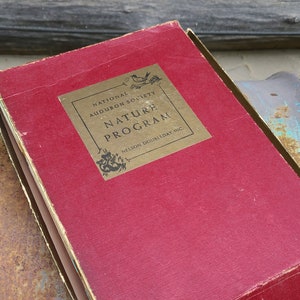 May include: A red hardcover book with gold lettering on the spine. The title is "National Audubon Society Nature Program" with the publisher "Nelson Doubleday, Inc." printed below.
