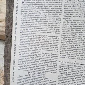 May include: A black and white newspaper article about the ballet Swan Lake, featuring a photo of conductor Antal Dorati. The article discusses the history of the ballet, the music, and the choreography. The text includes the title "Antal Dorati Conducting The Music Of Tchaikovsky's Swan Lake" and the subheading "Hi-Fi Facts and Notes About The Sleeping Beauty and Swan Lake".