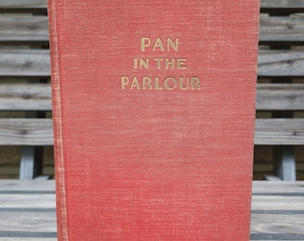 May include: A red hardcover book with the title "Pan in the Parlour" and the author's name "Norman Lindsay" printed in gold lettering.