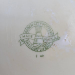 May include: Green and white logo on a white background. The logo reads "The Padden City Potteries Made in U.S.A."