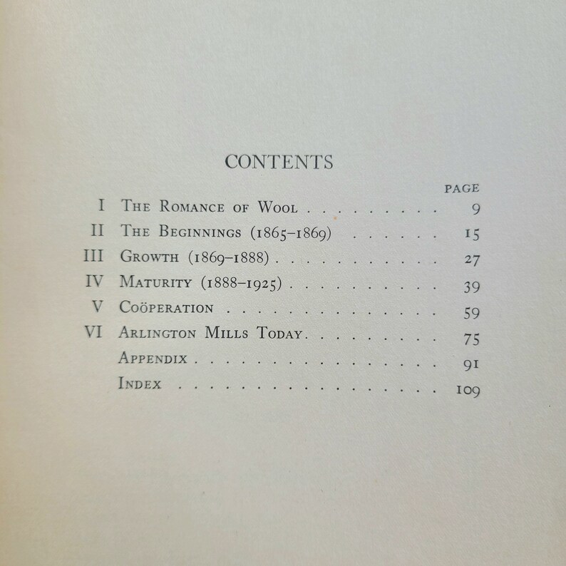 May include: A black and white book with the title "CONTENTS" printed in bold at the top of the page. The book lists the chapters and page numbers for a book about the history of Arlington Mills.