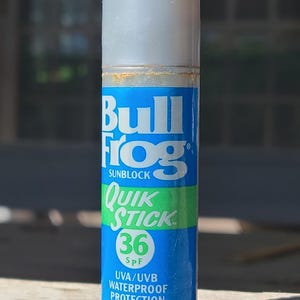 May include: A white ceramic mug with a black handle and the text "But First, Coffee" in a black, bold font. The mug is on a white surface.