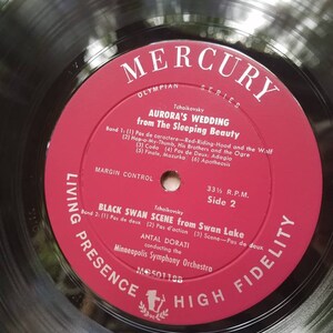 May include: A red vinyl record with the title "Mercury Olympian Series" and the text "Tchaikovsky Aurora's Wedding from The Sleeping Beauty" on the label. The record is labeled "Living Presence High Fidelity" and has the number "MC50118B" printed on it.