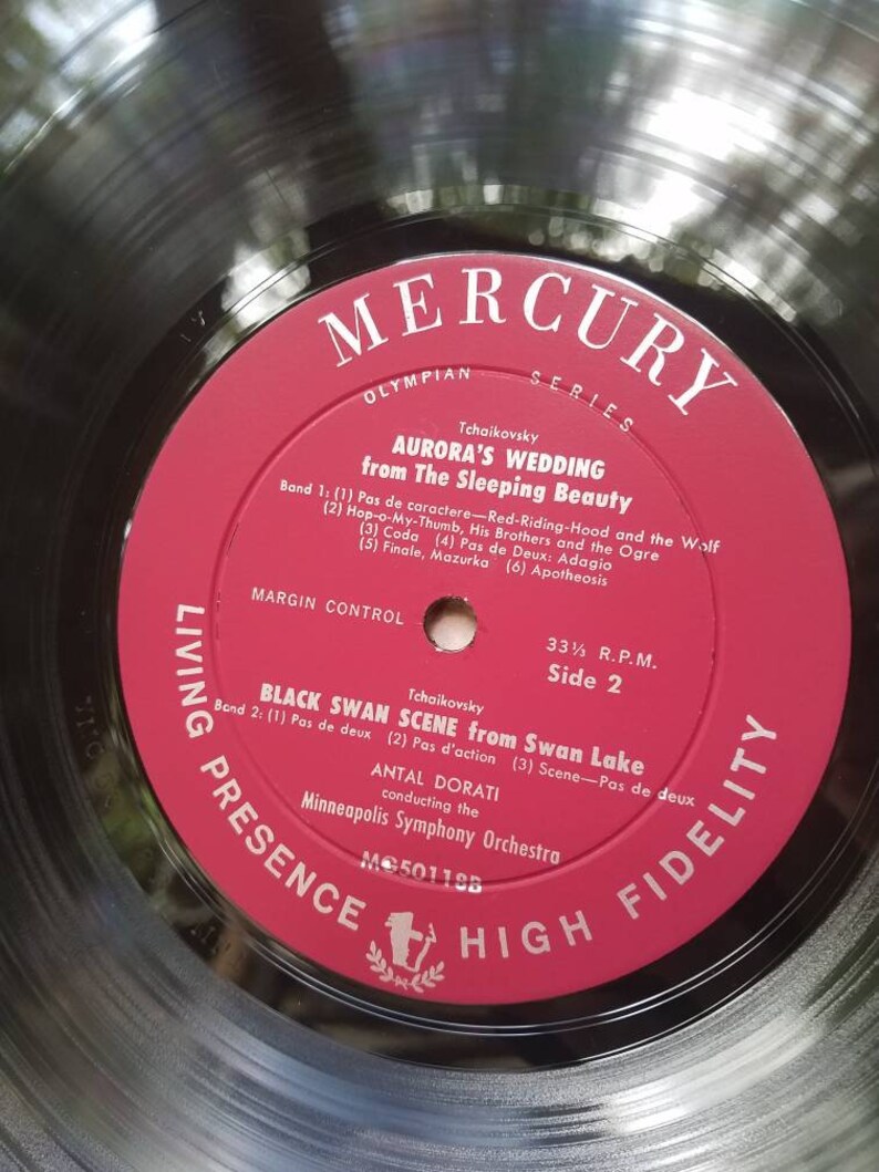 May include: A red vinyl record with the title "Mercury Olympian Series" and the text "Tchaikovsky Aurora's Wedding from The Sleeping Beauty" on the label. The record is labeled "Living Presence High Fidelity" and has the number "MC50118B" printed on it.
