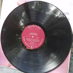 May include: A black vinyl record with a red label. The label has the text "Mercury" in a white circle with the text "Living Presence High Fidelity" around the circle. The text "Aurora's Wedding from The Sleeping Beauty" is printed on the label.