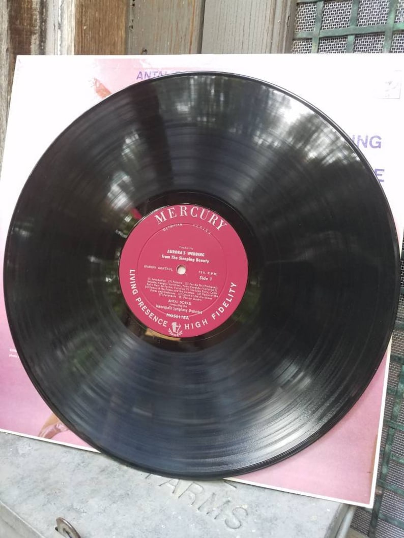May include: A black vinyl record with a red label. The label has the text "Mercury" in a white circle with the text "Living Presence High Fidelity" around the circle. The text "Aurora's Wedding from The Sleeping Beauty" is printed on the label.