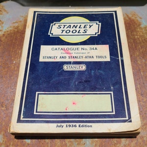 May include: A blue and white vintage Stanley Tools catalogue from July 1936. The cover features the Stanley Tools logo and the text "Catalogue No. 34A Combined Catalogue of STANLEY AND STANLEY-ATHA TOOLS".