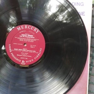 May include: A black vinyl record with a red label. The label has the text "Mercury Living Presence High Fidelity" and the title "Black Swan Scene from Swan Lake" by Antal Dorati and the Minneapolis Symphony Orchestra.
