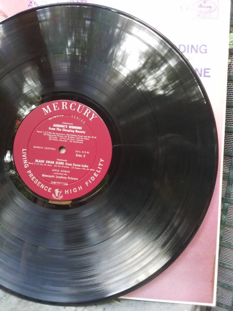 May include: A black vinyl record with a red label. The label has the text "Mercury Living Presence High Fidelity" and the title "Black Swan Scene from Swan Lake" by Antal Dorati and the Minneapolis Symphony Orchestra.