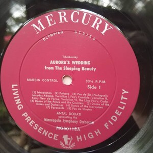 May include: A red vinyl record with a black label. The label features the text "Mercury Olympian Series" and "Tchaikovsky Aurora's Wedding from The Sleeping Beauty". The record is labeled "Living Presence High Fidelity" and "MG50118A".