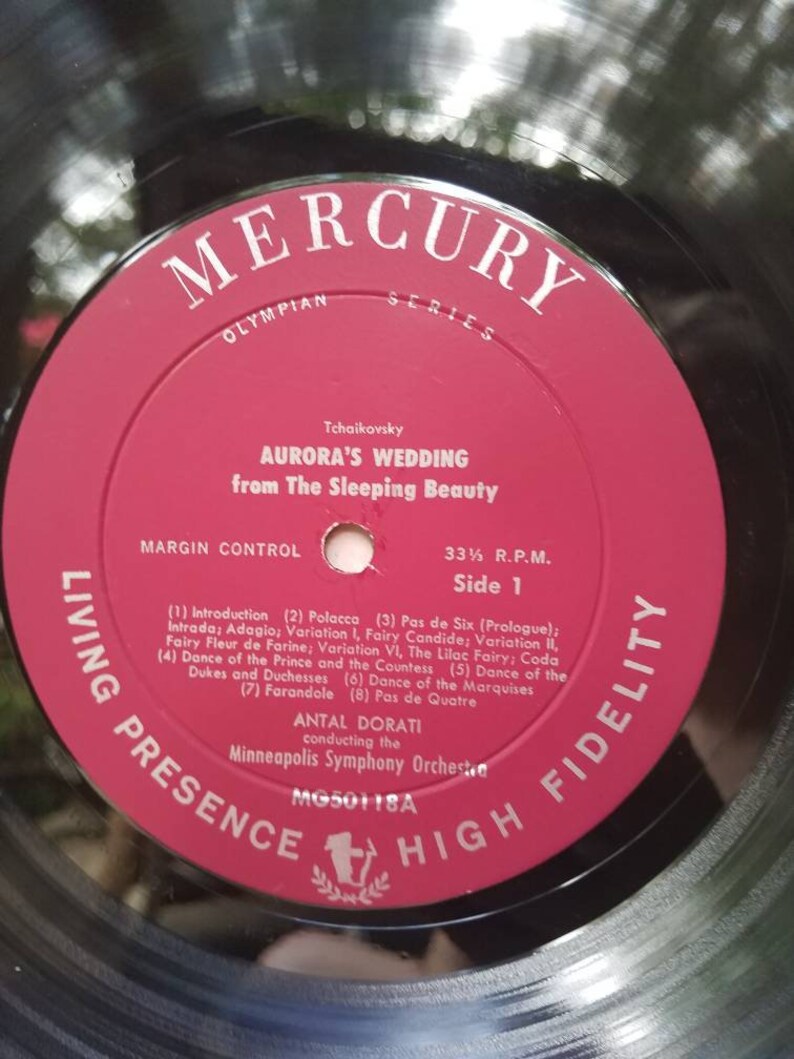 May include: A red vinyl record with a black label. The label features the text "Mercury Olympian Series" and "Tchaikovsky Aurora's Wedding from The Sleeping Beauty". The record is labeled "Living Presence High Fidelity" and "MG50118A".