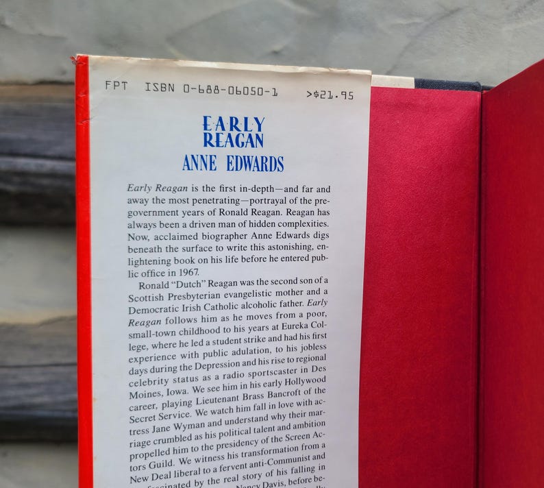 May include: A hardcover book titled "Early Reagan" by Anne Edwards. The book's spine is red with white text, and the interior pages are red. The book's text describes the early life of Ronald Reagan.