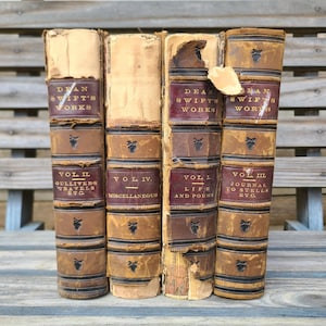 May include: Four antique leather-bound books with gold lettering. The books are titled "Dean Swift's Works" and each volume contains a different work by the author. The volumes are: "Vol II Gulliver's Travels etc.", "Vol IV. Miscellaneous", "Vol I Life and Poems", and "Vol III Journal to Stella etc."
