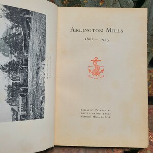 May include: A black and white photo of a building with the text "Arlington Mills 1865-1925" and a red anchor with the text "Trade Mark Skill Wins Trick" printed on a white page.