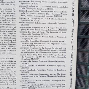 May include: A close-up of a black and white sign with a list of classical music recordings by the Minneapolis Symphony Orchestra. The sign is titled "Other Mercury LIVING PRESENCE high fidelity recordings by Antal Dorati".