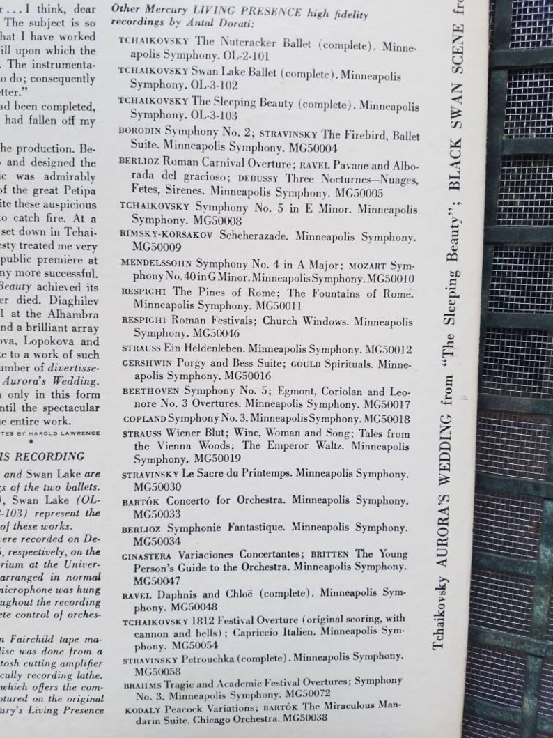 May include: A close-up of a black and white sign with a list of classical music recordings by the Minneapolis Symphony Orchestra. The sign is titled "Other Mercury LIVING PRESENCE high fidelity recordings by Antal Dorati".
