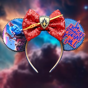 May include: Blue and red Minnie Mouse ears with a red sequined bow, a gold Guardians of the Galaxy logo, and a blue ear with the text "I'm Mary Poppins Y'all".