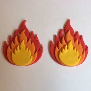 May include: Two red, orange, and yellow fondant flames. The flames are layered to create a 3D effect.