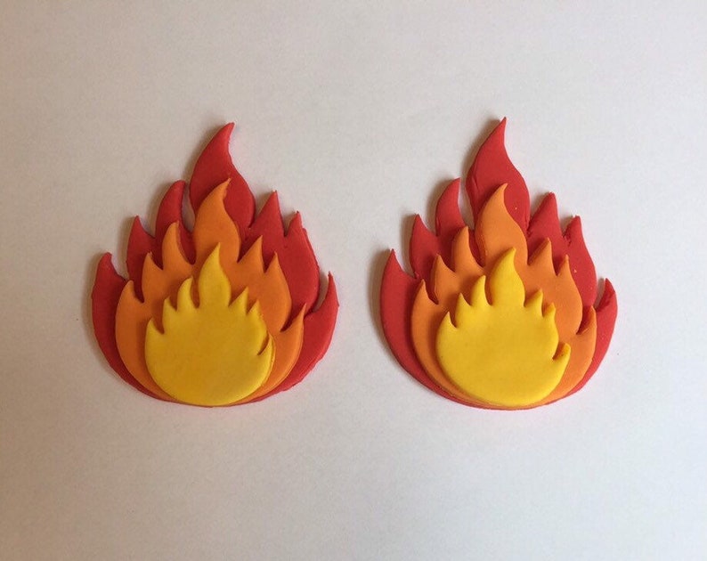 May include: Two red, orange, and yellow fondant flames. The flames are layered to create a 3D effect.