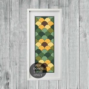 Pode incluir: Um padrão de ponto cruz enquadrado com um design geométrico de círculos sobrepostos de amarelo, verde e marrom. O padrão é intitulado "Download de PDF apenas".