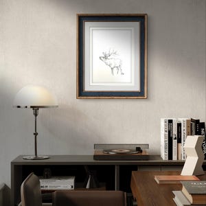 May include: A framed black and white line drawing of a deer with antlers, hanging on a light gray wall. The frame is dark blue with a gold trim.