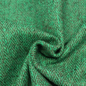 May include: Green and brown herringbone fabric with a textured weave.