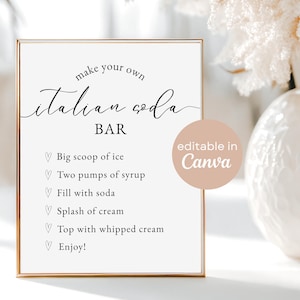 May include: A framed sign with the text "make your own Italian soda BAR" in elegant script. The sign includes instructions: big scoop of ice, two pumps of syrup, fill with soda, splash of cream, top with whipped cream, and enjoy.