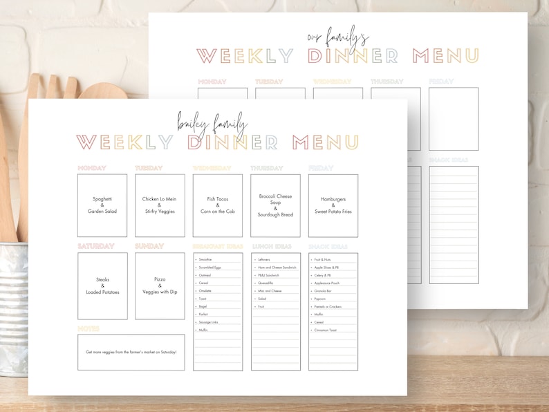 May include: Two white weekly dinner menu planners with colorful text. One is labeled "Bailey Family" and the other "Our Family's." Each planner has sections for daily meals, breakfast, lunch, and snack ideas. The "Bailey Family" planner includes meal ideas.