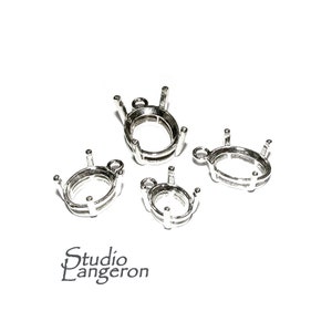 May include: Four silver oval-shaped pendant settings with prongs. The settings are different sizes and have a loop at the top for attaching a chain.
