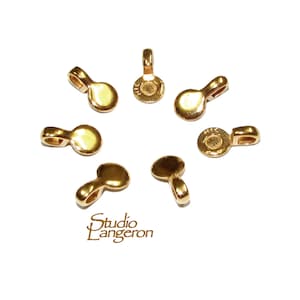 May include: Eight gold-toned metal pendant bails with a loop at the top and a flat circular base.