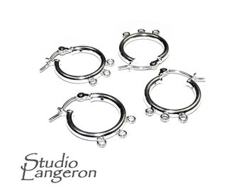 May include: Three silver hoop earrings with three jump rings on each hoop. The earrings are designed for adding charms or pendants.