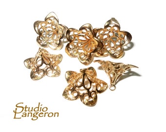 May include: Six gold metal flower-shaped pendant caps with intricate cut-out designs. The caps have a cone shape and are perfect for adding a touch of elegance to jewelry projects.