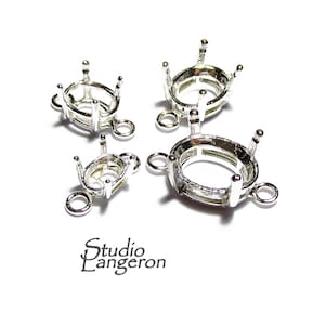 May include: Four silver oval-shaped bezel settings with three loops for attaching to jewellery. The bezels are different sizes.