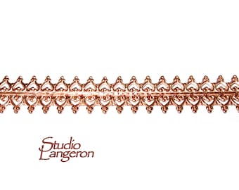 May include: A copper-colored metal trim with a repeating heart design. The trim is about 1/2 inch wide.