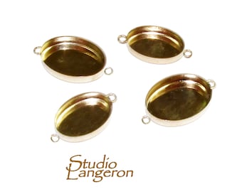 May include: Four gold-toned oval-shaped metal pendant trays with a loop on each side. The trays are designed to hold cabochons or other decorative elements.