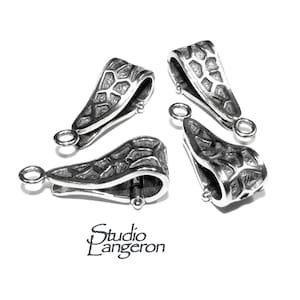 May include: Four silver-toned pendant clasps with a textured, geometric design. Each clasp has a small loop on either end.