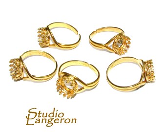 May include: Four gold-toned adjustable rings with a crown-shaped bezel setting. Each ring has a delicate, twisted band.