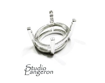 May include: Silver oval prong setting for a gemstone. The setting has a double row of prongs and is designed to hold a stone securely.