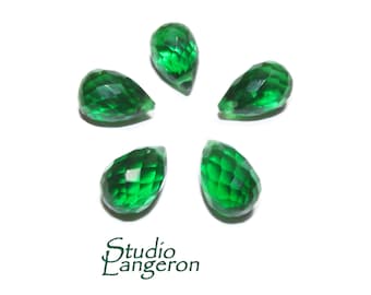 May include: Five emerald green faceted teardrop shaped crystal beads.