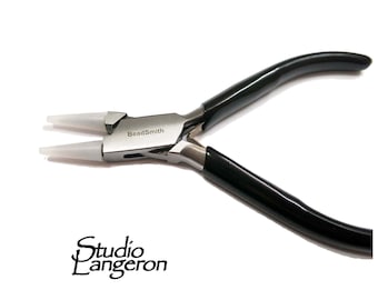 May include: A pair of silver-toned pliers with black rubber handles and white tips. The pliers are labeled "BeadSmith".