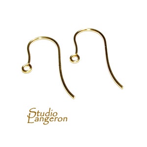 May include: Two gold-colored earring hooks. The hooks are made of metal and have a simple design.