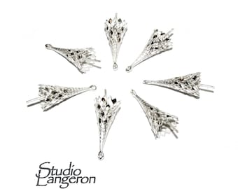 May include: Seven silver metal cone-shaped bead caps with a decorative openwork design. The caps have a loop at the top for attaching to jewelry.