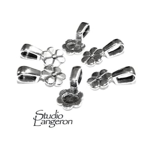 May include: Six silver flower-shaped pendant bails with a loop at the top. The bails are designed to attach to a chain or cord.