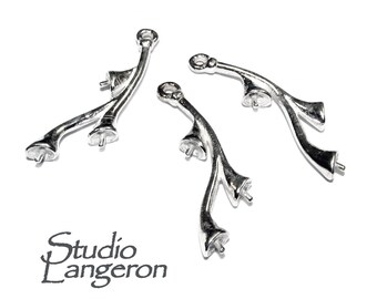 May include: Three silver-toned metal pearl pendant connectors with a branch-like design. Each connector has three prongs for attaching pearls.