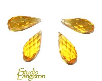 May include: Four amber-coloured faceted teardrop-shaped glass beads.