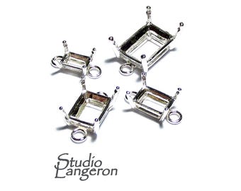 May include: Four silver-toned metal bezel settings with jump rings. The bezels are rectangular and have a smooth finish. They are designed to hold gemstones or other decorative elements.
