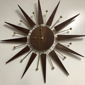 Kate’s Starburst hand crafted , walnut body and rays, brass accents. Quartz movement, battery operated.Mid-century modern,retro