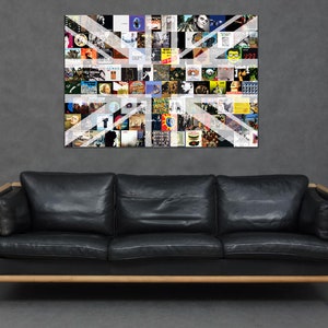 May include: A black leather sofa with wooden arms and legs, in front of a wall with a framed collage of album covers in the shape of the Union Jack flag.
