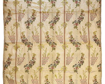 May include: A cream-colored fabric with a repeating pattern of floral bouquets in shades of pink, green, and blue. The bouquets are arranged in a grid pattern and are surrounded by a delicate geometric design.