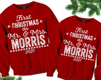 May include: Red Christmas sweaters with the text "First Christmas as Mr. & Mrs. MORRIS" and the year 2021.